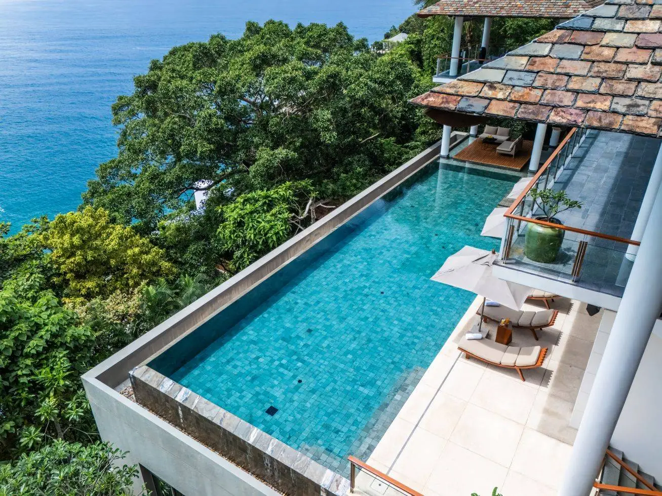 Looking down the 18 metre infinity pool at Baan Banyan Villa, with the slate-tiled roof and the Andaman Sea beyond