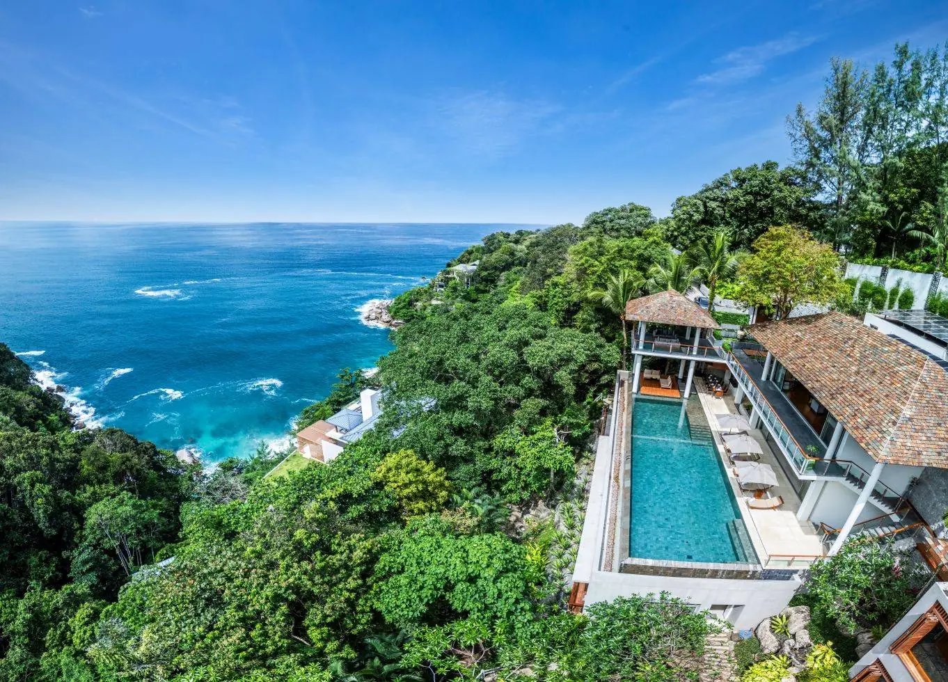 Aerial view of Baan Banyan Villa, its infinity pool and the bay below