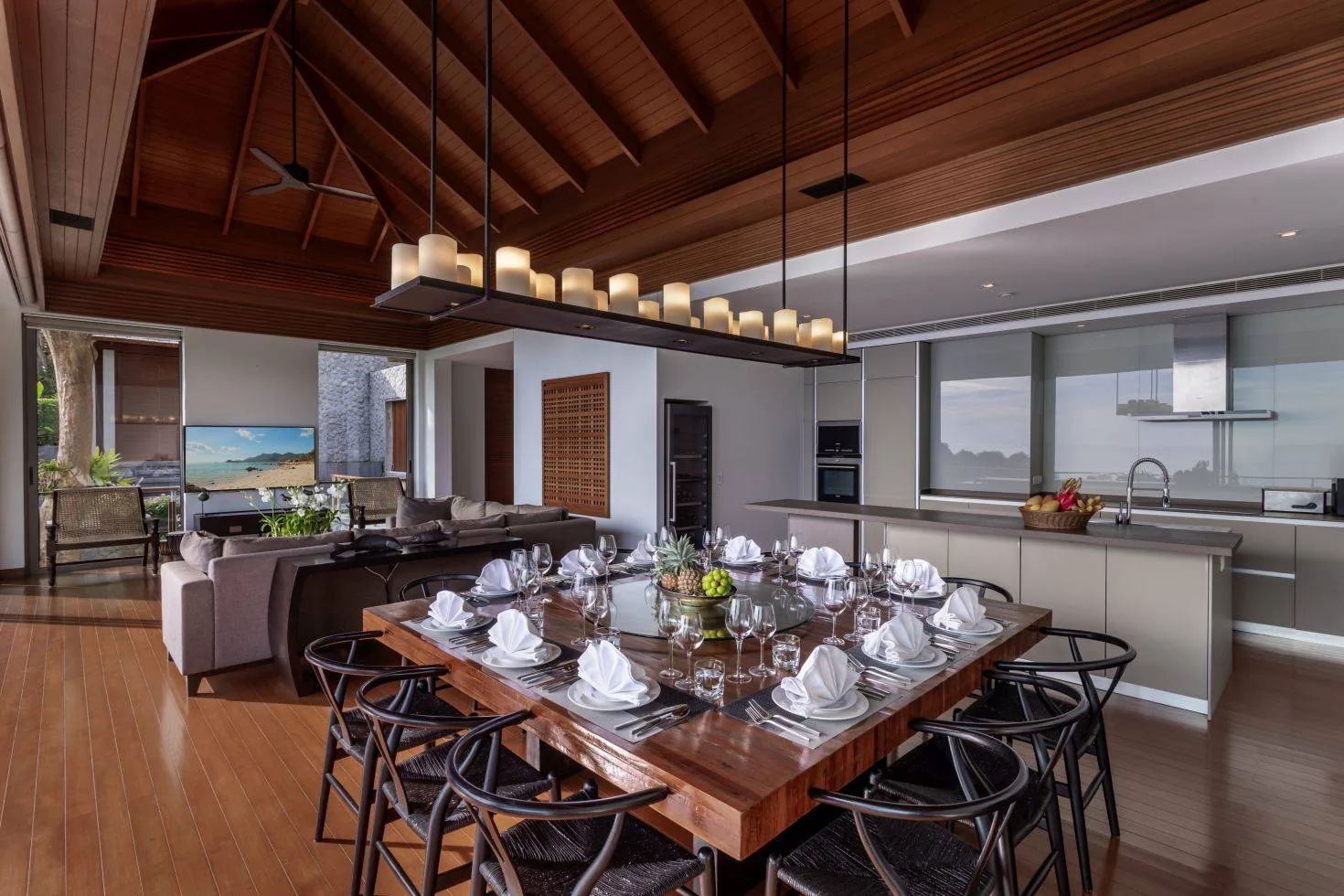 A dining table set for a meal, with the kitchen visible behind